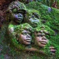 Large mossy pottery sculpture at William Ricketts Sanctuary featuring children