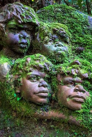 Large mossy pottery sculpture at William Ricketts Sanctuary featuring children