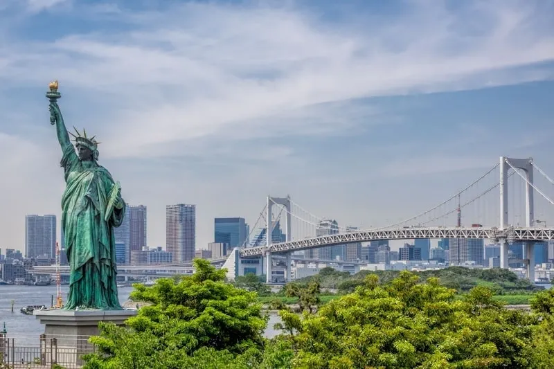 Statue of Liberty in the foreground looking across Tokyo Bay from Odaiba