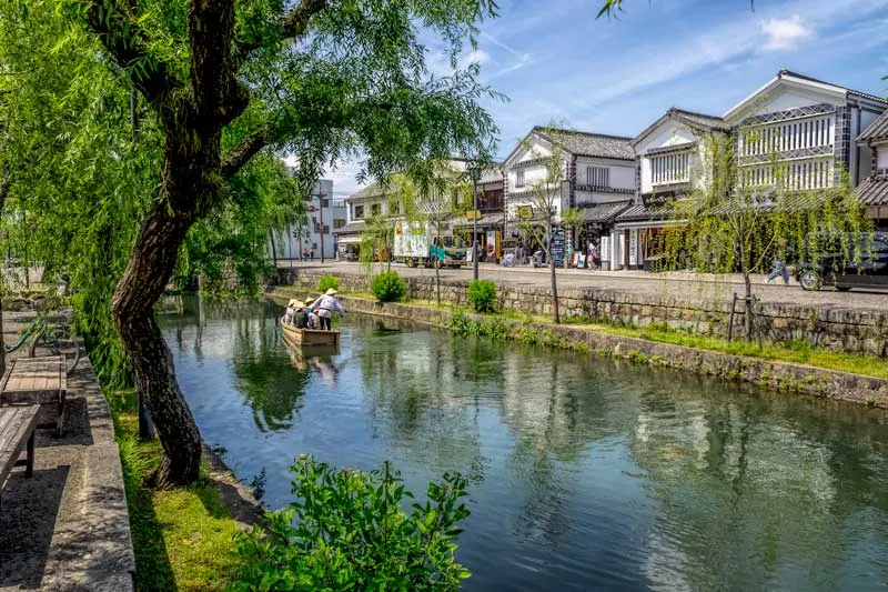 White storehouses from the Edo period still stand beside the  canal in Kurashiki