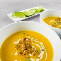 Bowls of homemade spicy Thai pumpkin soup