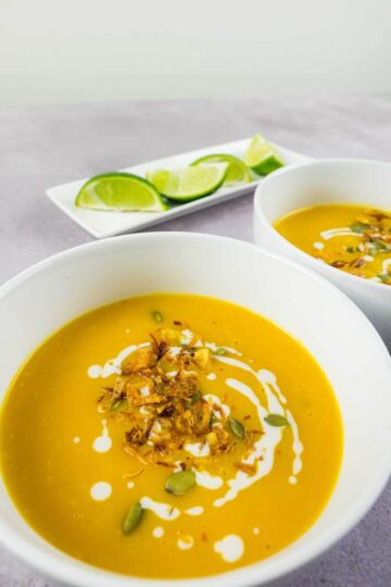 Bowls of homemade spicy Thai pumpkin soup