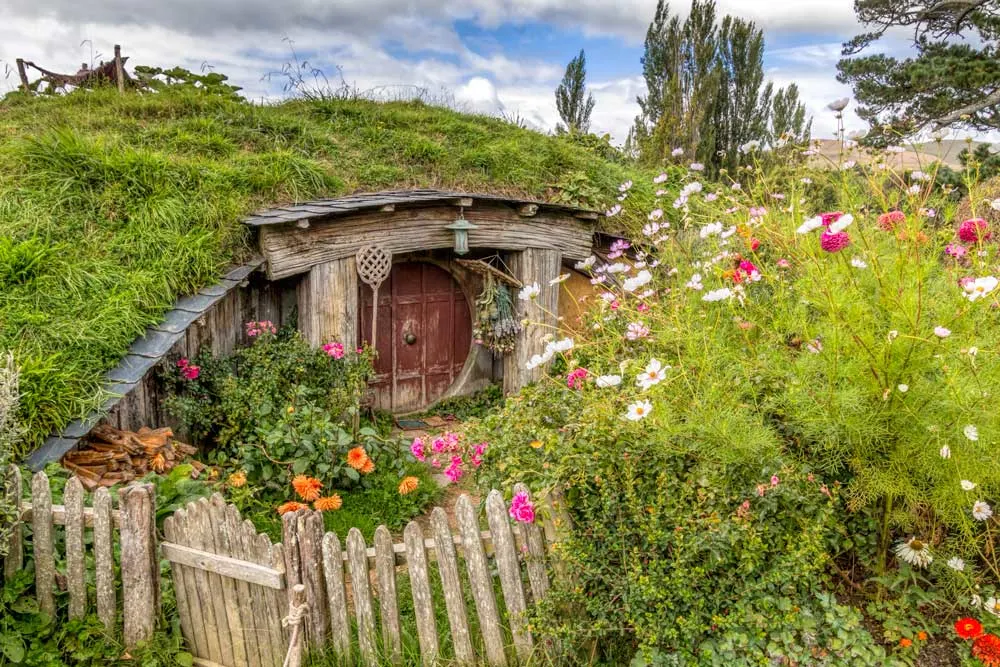 Hobbit hole surrounded by cottage garden flowers