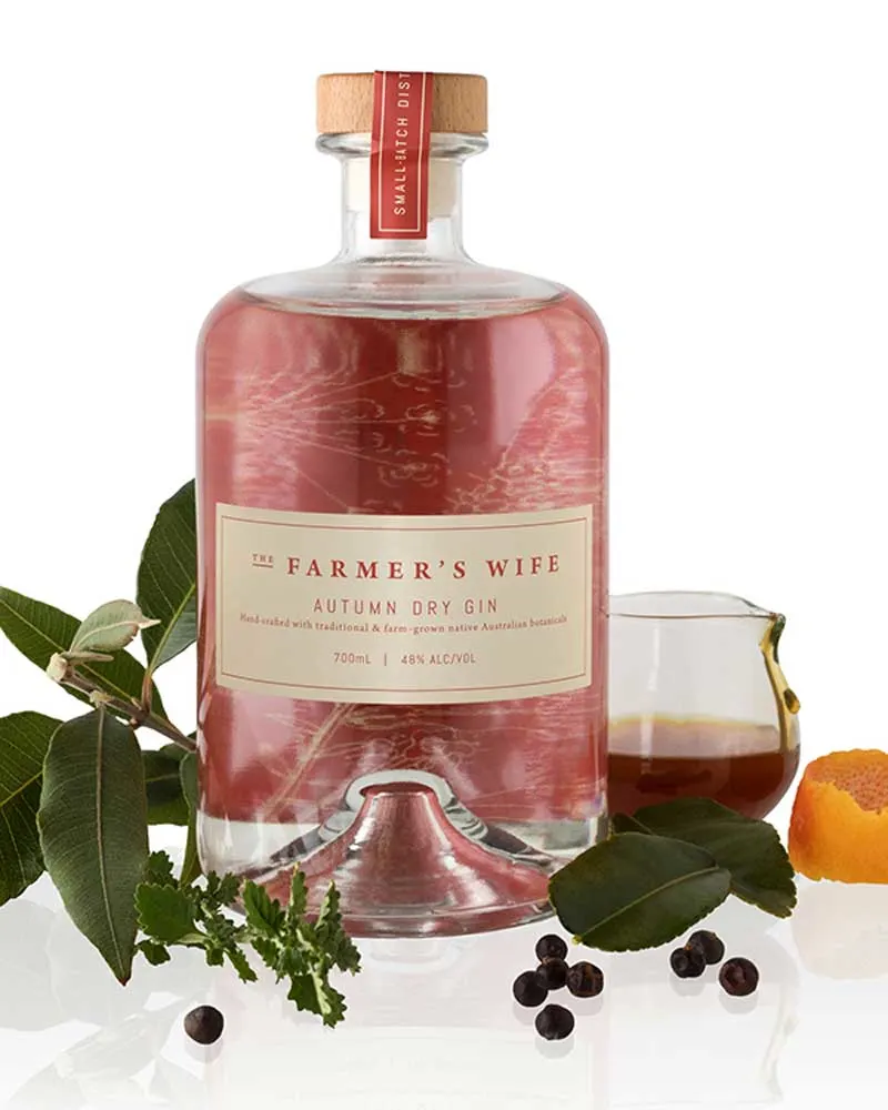 The Farmers Wifes craft autumn gin surrounded by botanicals