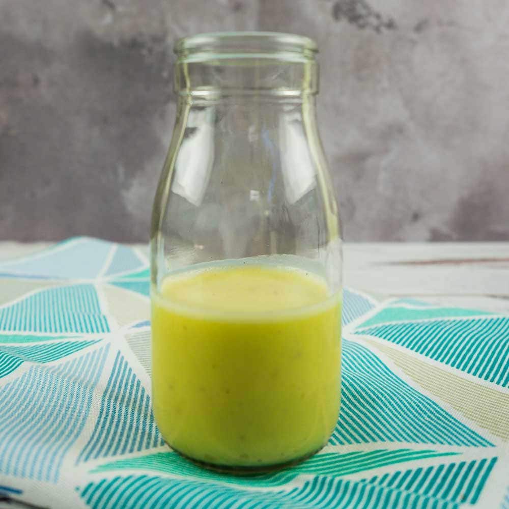 half full glass bottle of citrus dressing