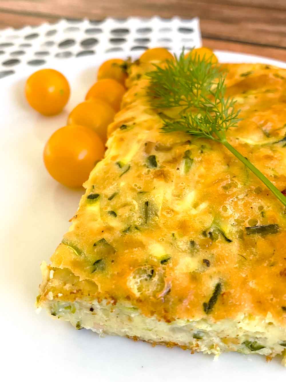 Zucchini and bacon slice on white plate