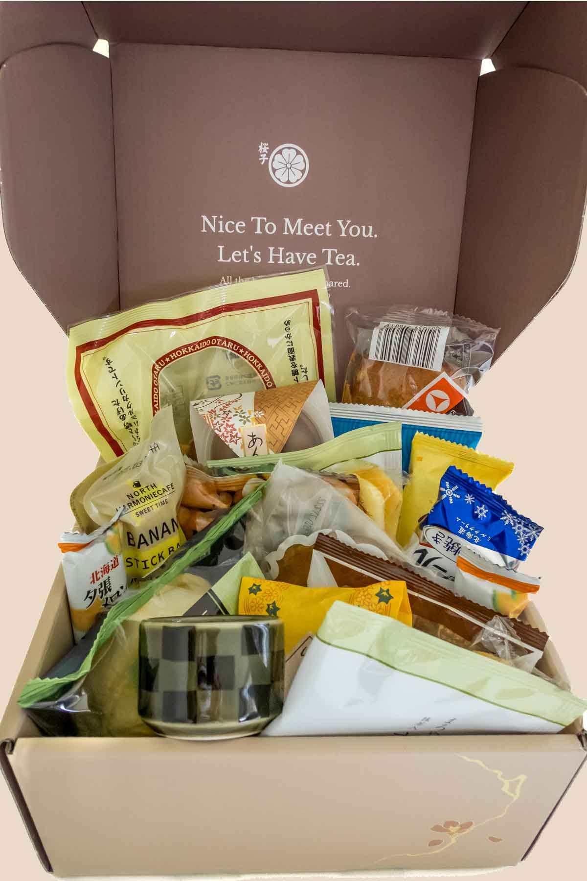 The December Sakuraco Japanese snack box open on table