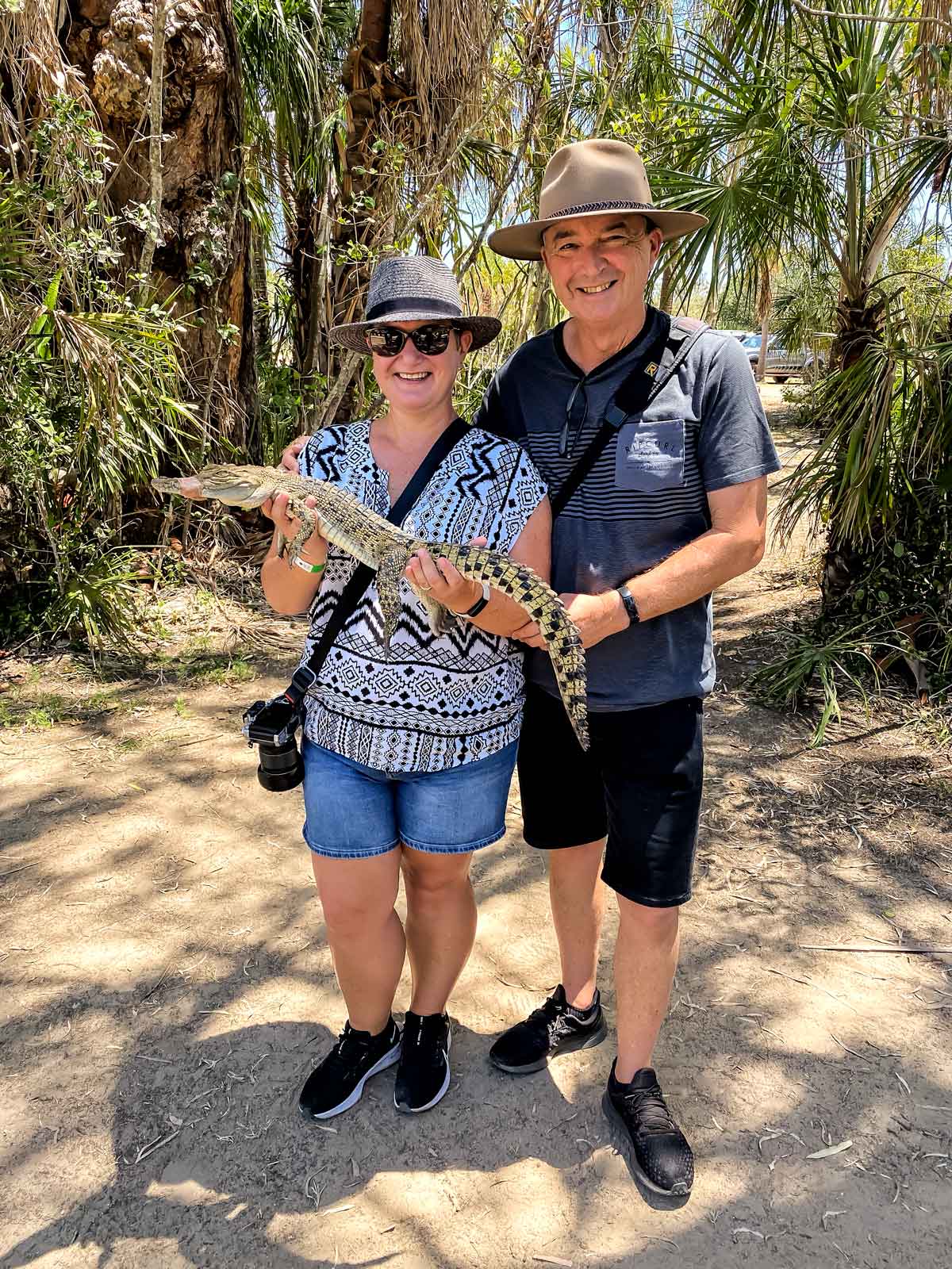 Couple hold 2 year old crocodile at Koorana Crocodile farm