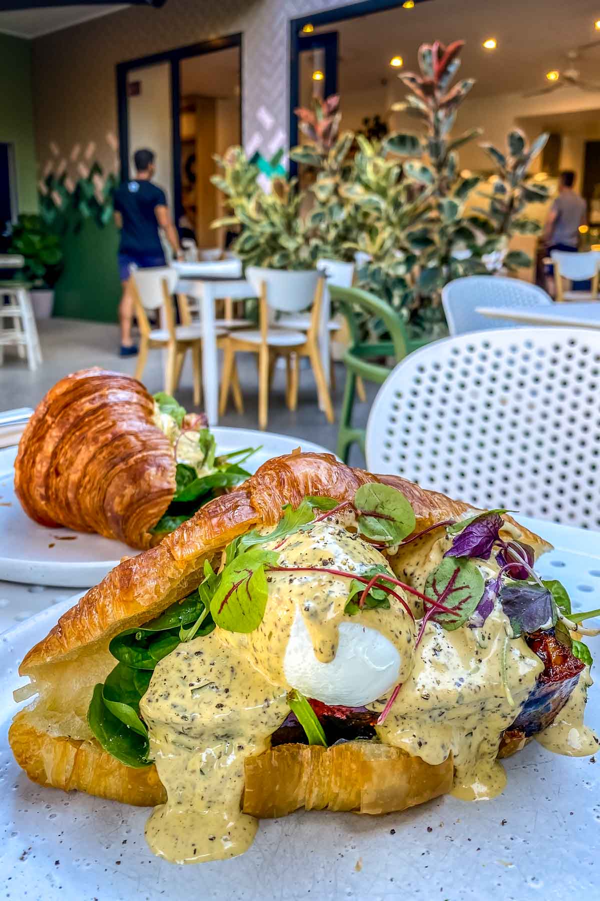 Feature photo - best cafes in Brisbane - eggs benedict on white table
