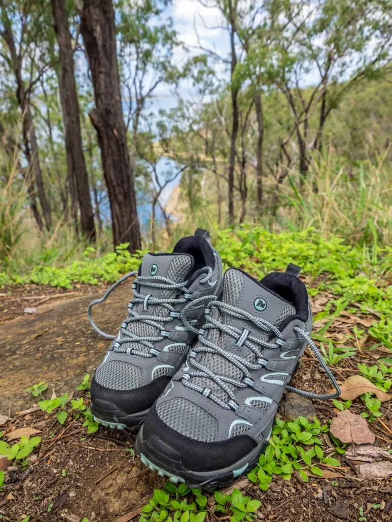 Merrell Moab hiking shoes in front of bush and Lake Awoonga backdrop