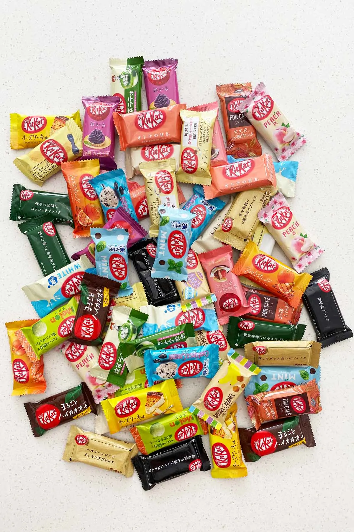 snack sized kitkats in many flavours on white stone benchtop