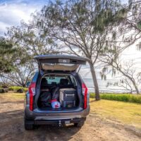 Road trip essentials - 4WD at beach with tailgate open