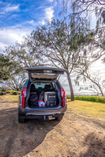 Road trip essentials - 4WD at beach with tailgate open