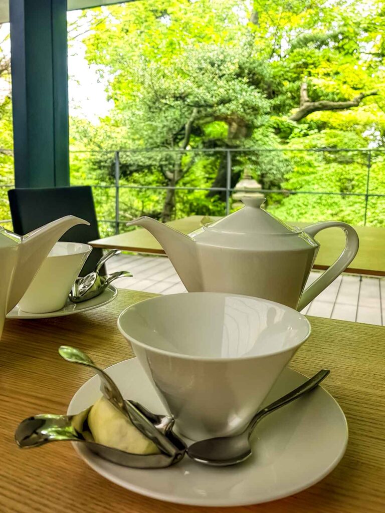 teaset on table of Japanese cafe with leafy scene beyond the window