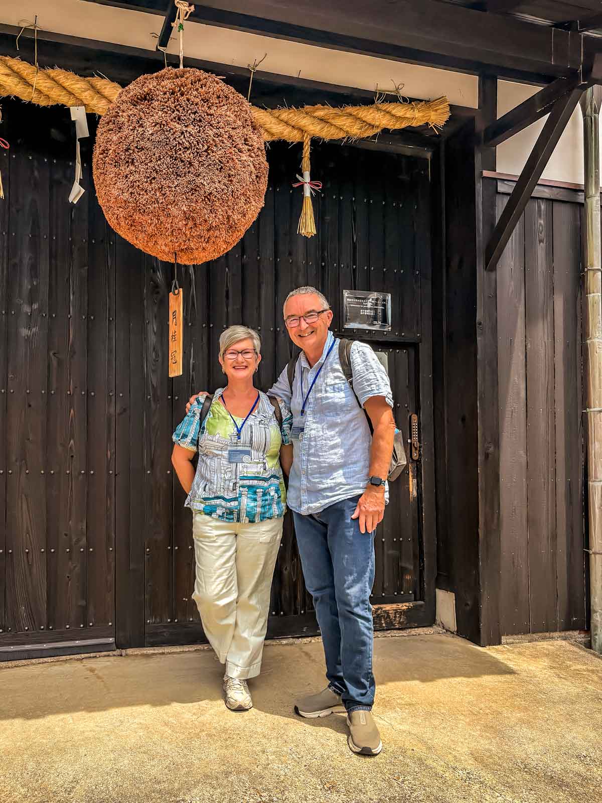 under a sugidama, the aged cedar ball that denotes a sake distributor or brewer